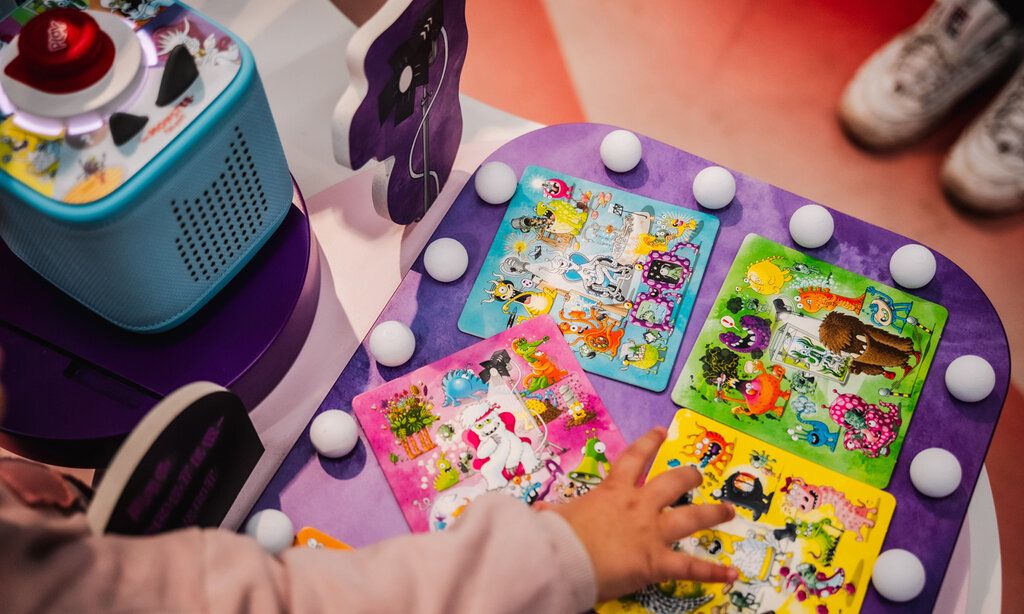 Toniesbox mit Spielkarten und Kinderhand