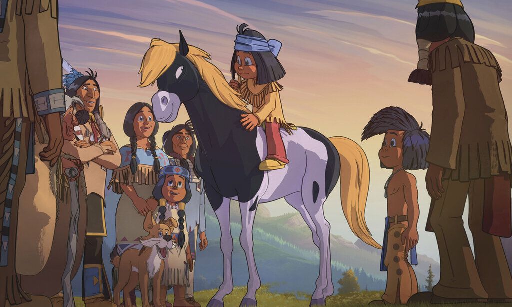 Zeichentrickfilm, Yakari sitzt auf einem Pferd, um ihn herum stehen Erwachsene, Kinder und ein Hund
