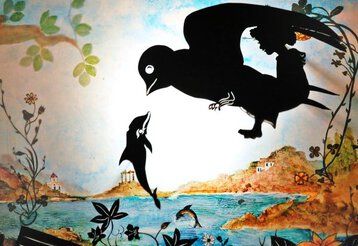 Scherenschnitt eines Vogels und eines Delfins vor der Kulisse eines Insel im Meer.