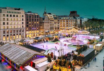 Corneliusplatz mit Eisbahn und DEG-Winterwelt von oben in der Dämmerung