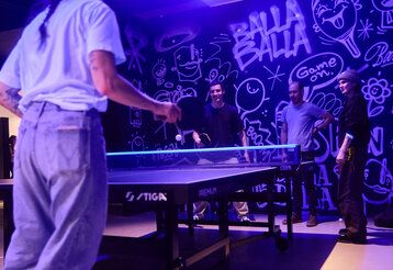 Leute spielen Tischtennis in den Räumen von BallaBalla