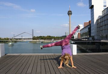 Kind schlägt ein Rad vor Düsseldorf Kulisse