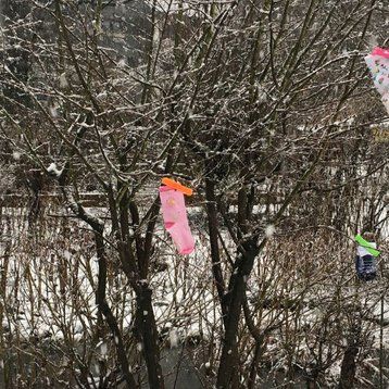 Gebastelte Eiskunst hängt in einem winterlichen Baum